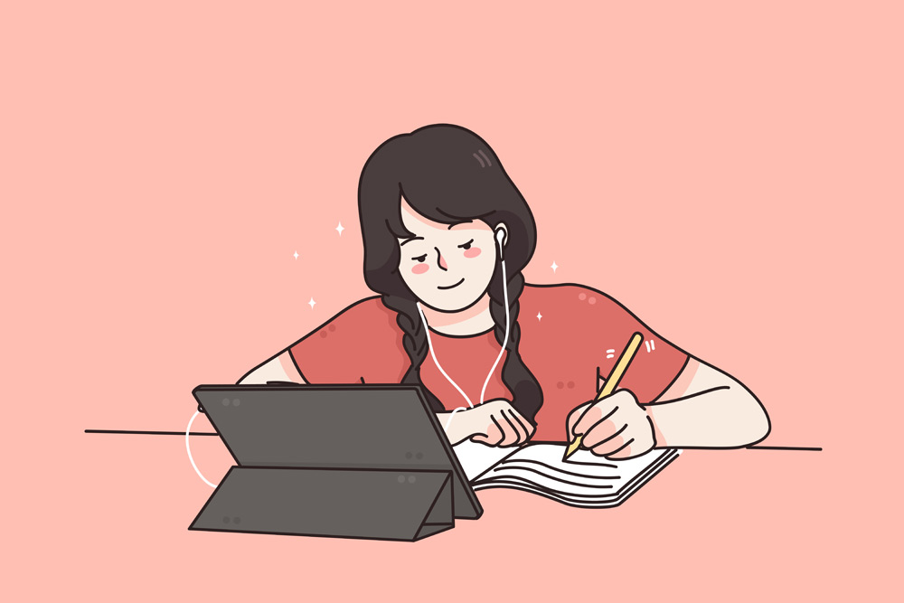 girl wearing headphones studying with pen, paper and tablet